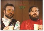 Two guys under mistletoe.