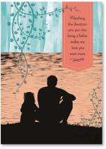 Father and child sitting at lake