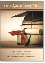 Grad hat on stack of books with diploma