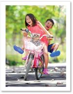 (PB) Girl and boy riding bike
